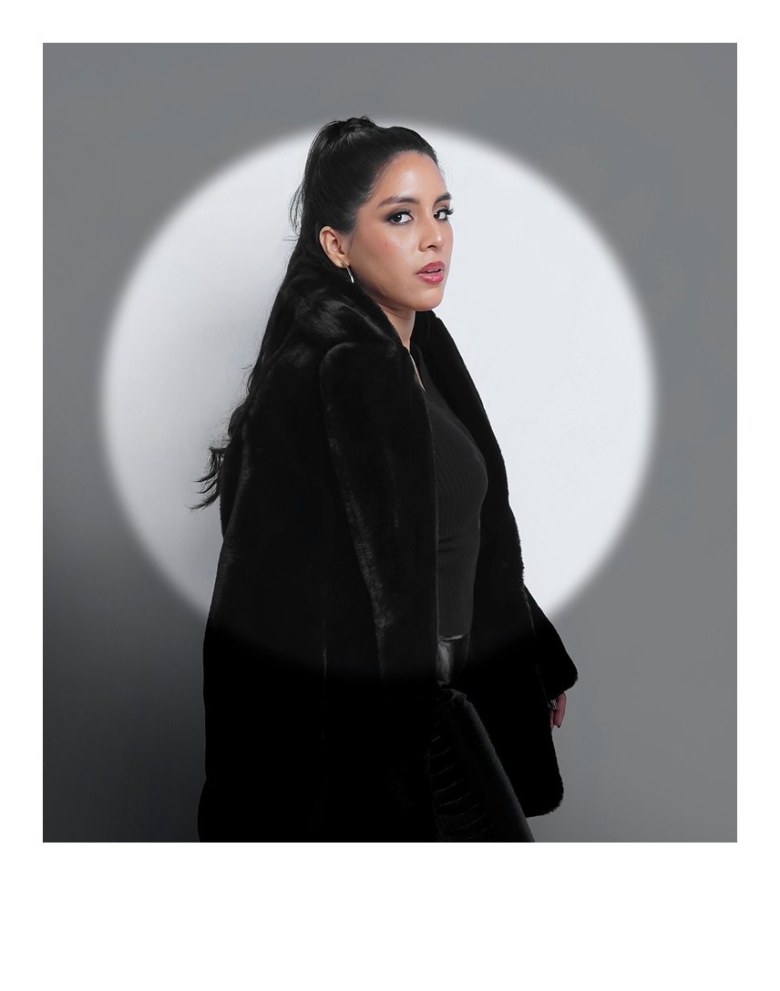Editorial portrait of Marcela under a spotlight